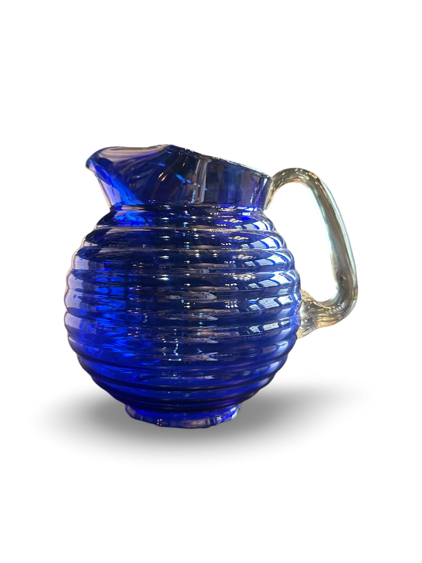 Vintage royal blue pitcher by Ozmun Home with a classic ceramic design and sturdy handle, perfect for serving beverages.