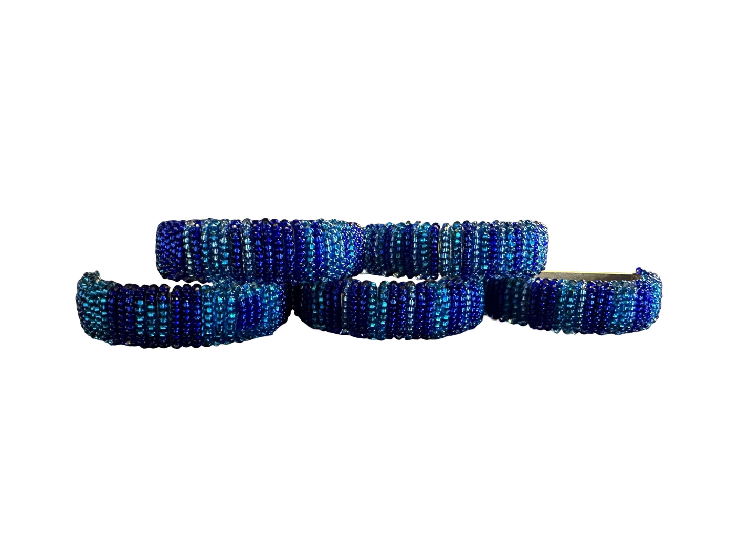 Set of five beaded napkin rings by Phoebe, featuring colorful, handcrafted bead designs for elegant table settings.