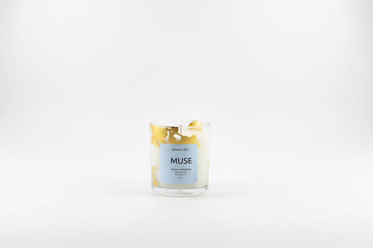 Ozmun Home Sahar N Art Candle showing a decorative candle with intricate design in a glass holder on a wooden surface.