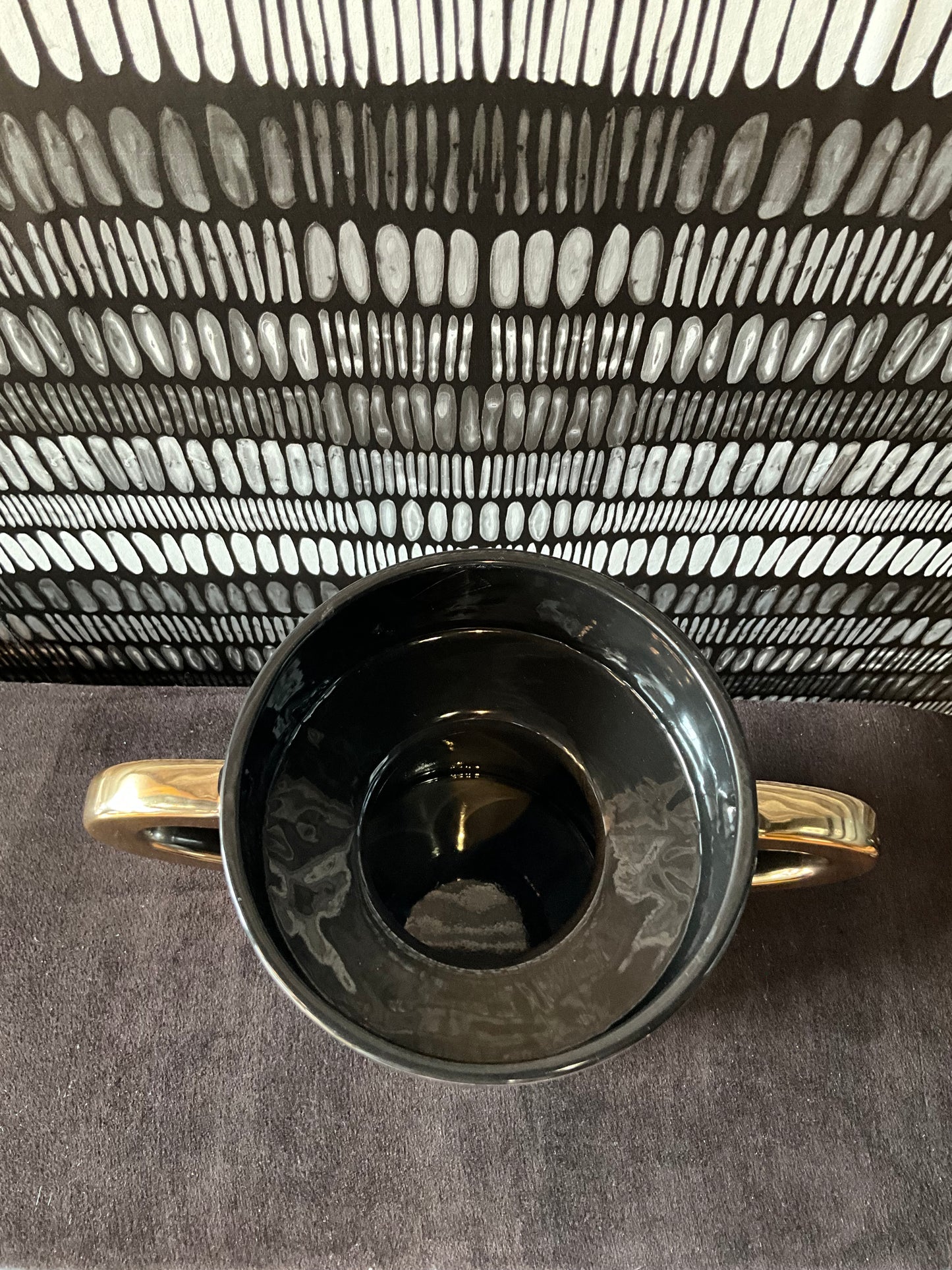 Black and gold ceramic vase by The Vault Creative featuring elegant design and a glossy finish.