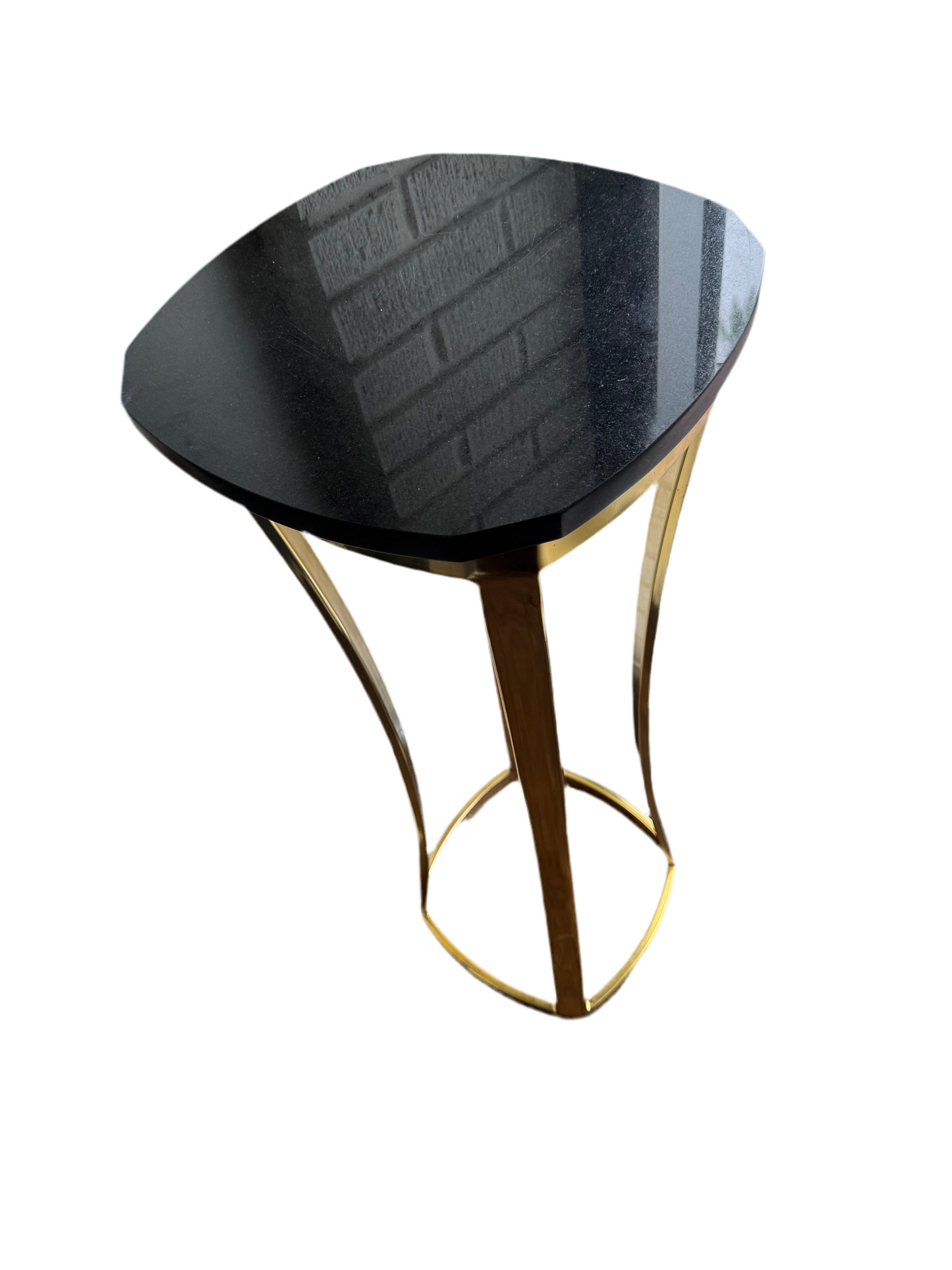 Brass and marble top pedestal by The Vault Creative, showcasing a sleek modern design with a round marble surface and brass base.