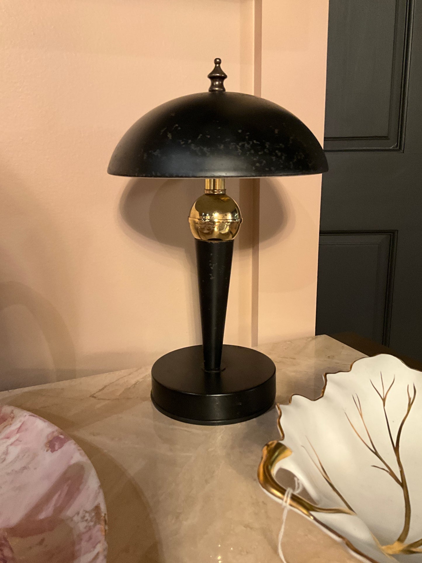 Small black metal table lamp by The Vault Creative with a sleek, modern design and a cylindrical lampshade.