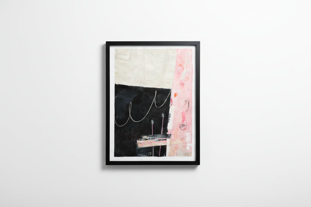 Framed abstract art piece on a white wall