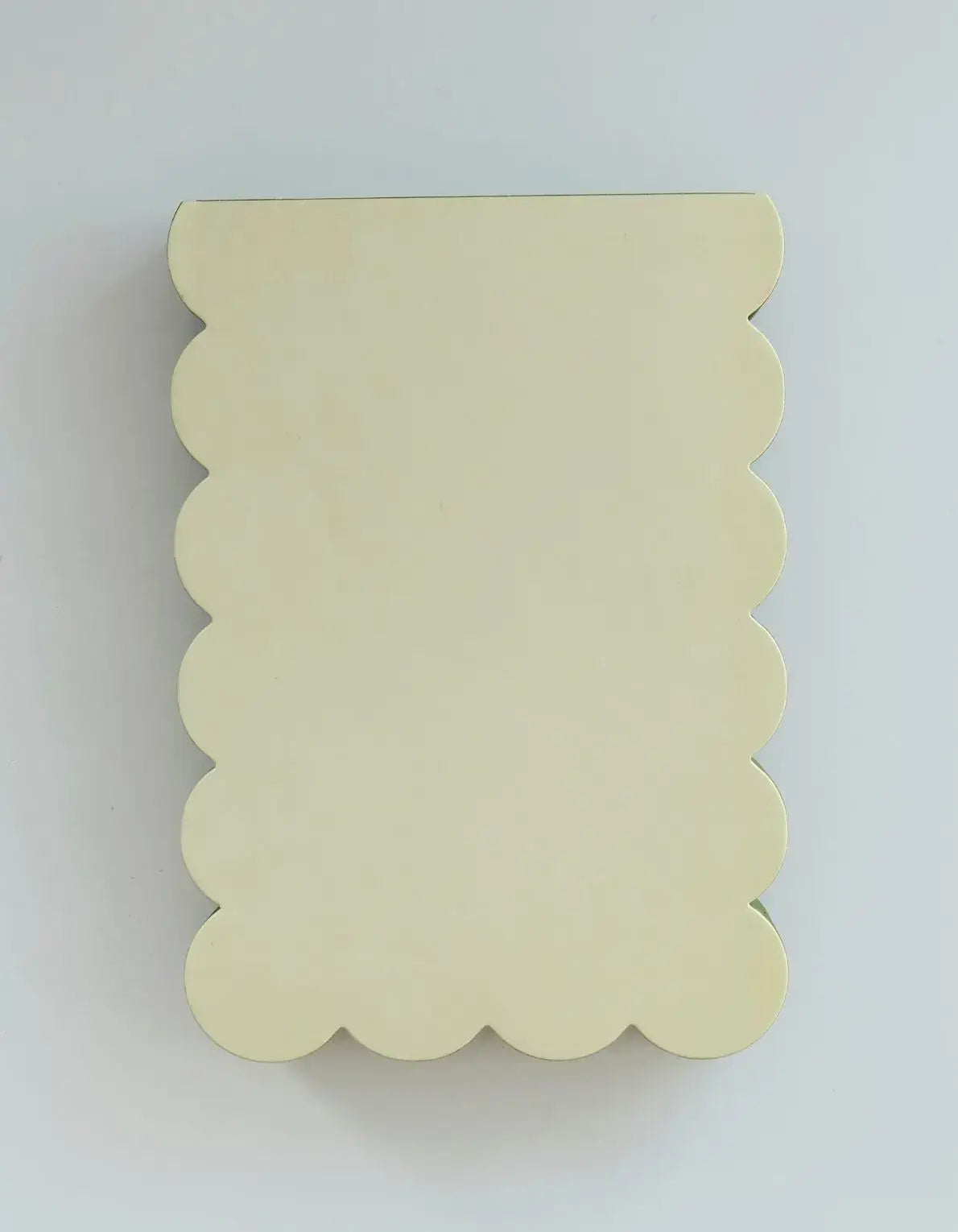 Scalloped shaped notepad with chartreuse and olive edge, Idlewild Co. logo on a white background with a decorative scalloped border.