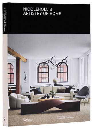 Open book titled "Nicole Hollis: Artistry of Home" showcasing interior design photography and elegant home decor ideas.