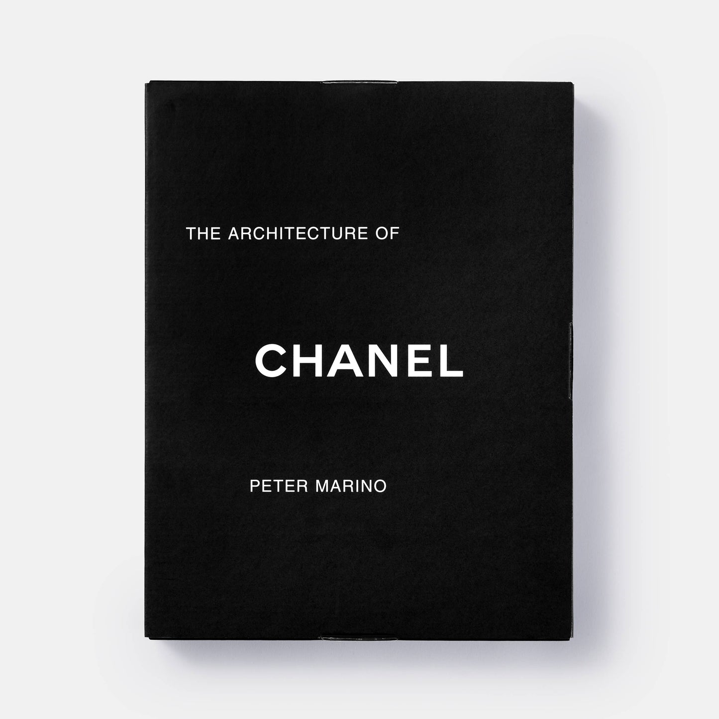 Book cover of "The Architecture of Chanel" by Phaidon featuring a Chanel-inspired building design and elegant architectural details.