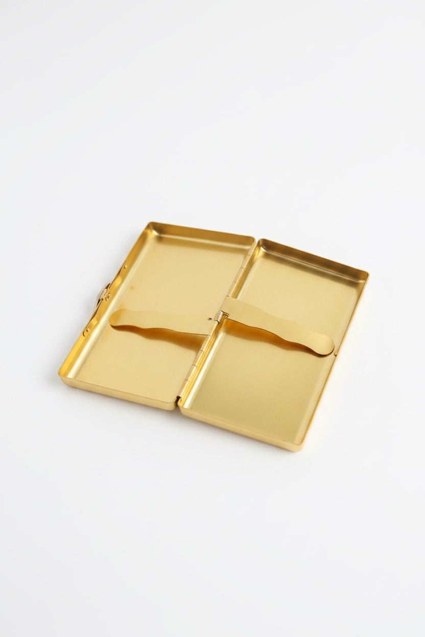 Gold and green P. Grunsfeld cigarette case by The Vault Creative, featuring a sleek, vintage-inspired design with elegant details.