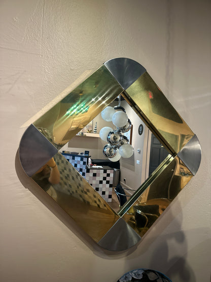 Jere Mirror by The Vault Creative showcasing a sleek, modern design with a reflective glass surface and stylish frame.
