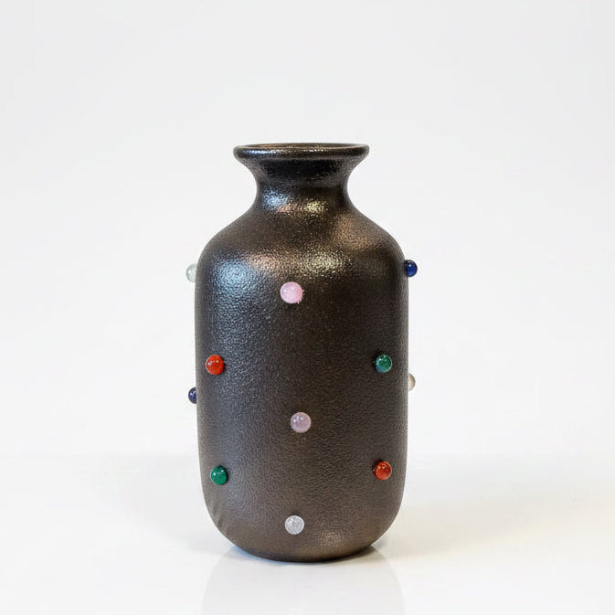 Marcia Bud Vase by P.Grunsfeld from The Vault Creative, featuring a sleek, handcrafted ceramic design with a narrow opening.