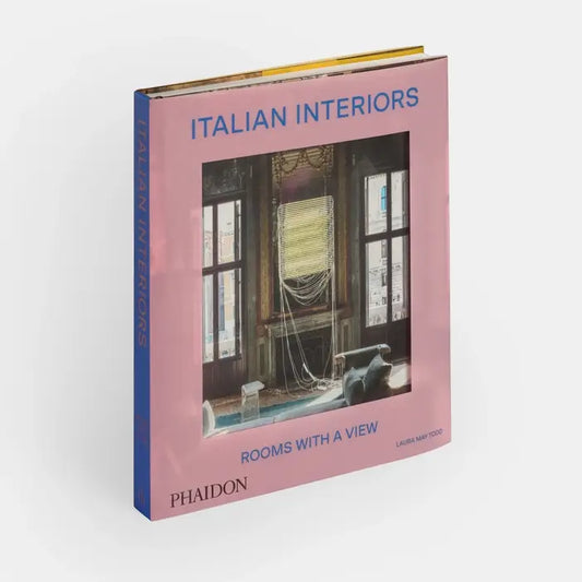 Cover of Italian Interiors: Rooms With A View book by Phaidon, featuring a stylish interior room with large windows and scenic views.