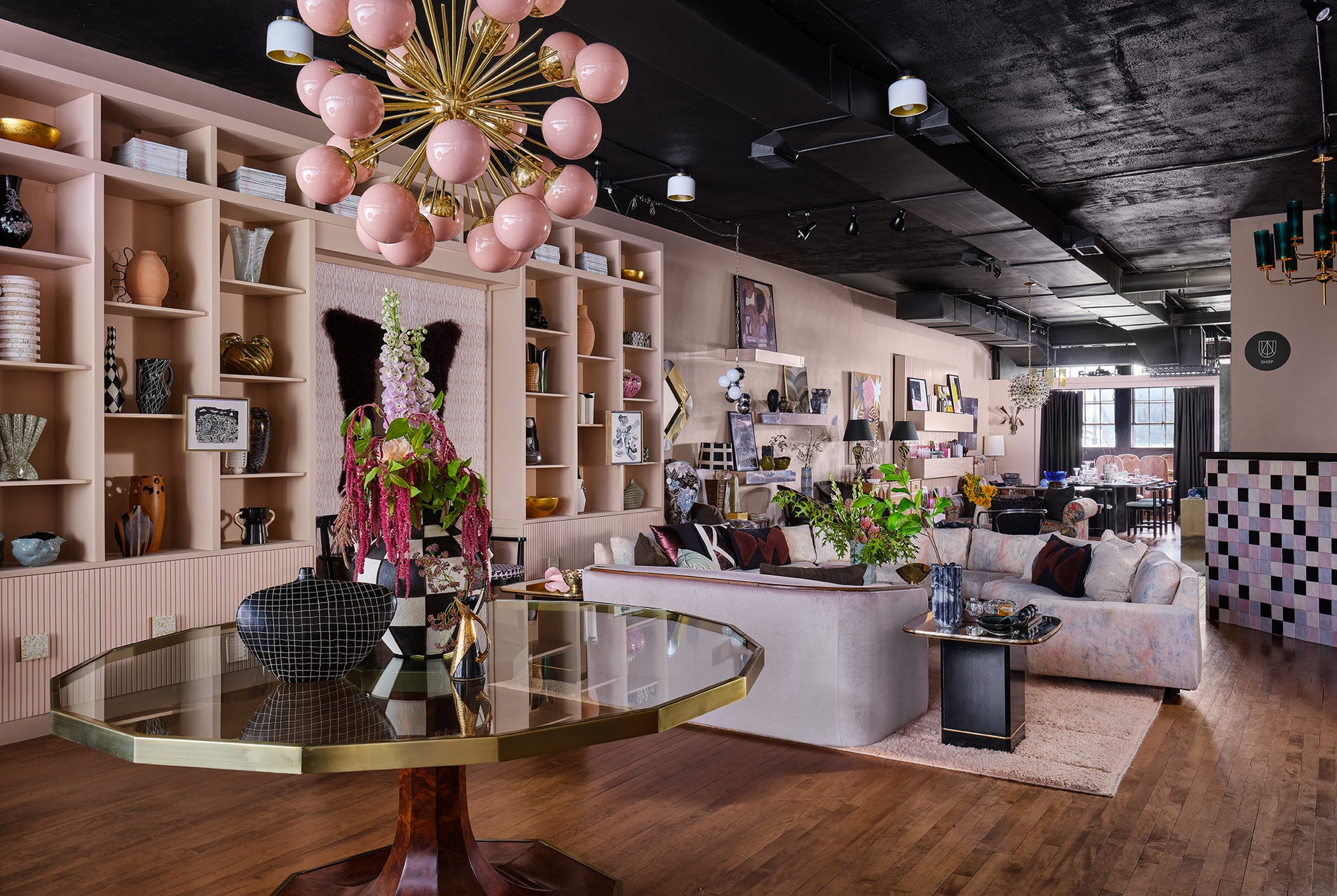 Pink Murano glass orb chandelier with multiple glass orbs hanging from a decorative fixture, designed by The Vault Creative.