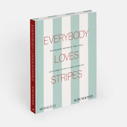 Open book titled "Everybody Loves Stripes: Decorating Between the Lines" by Phaidon, showcasing colorful striped patterns inside.