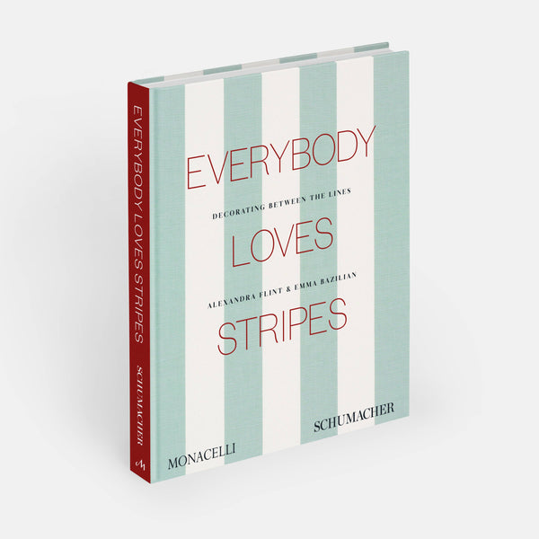 Open book titled "Everybody Loves Stripes: Decorating Between the Lines" by Phaidon, showcasing colorful striped patterns inside.