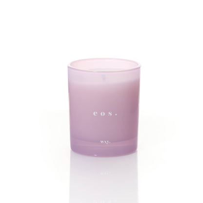WXY eos 7oz candle featuring Orris Root and Amber scent, shown with the candle in a glass jar and a lit wick.