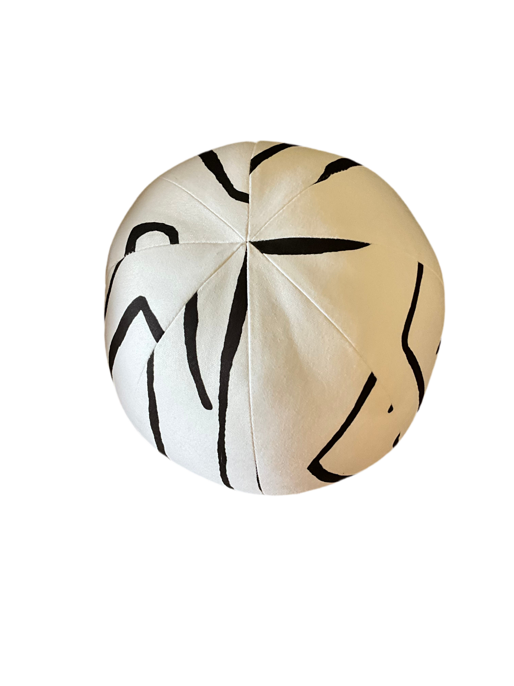 French Ball Pillow by The Vault Creative with soft, textured fabric and rounded shape, perfect for cozy home decor.