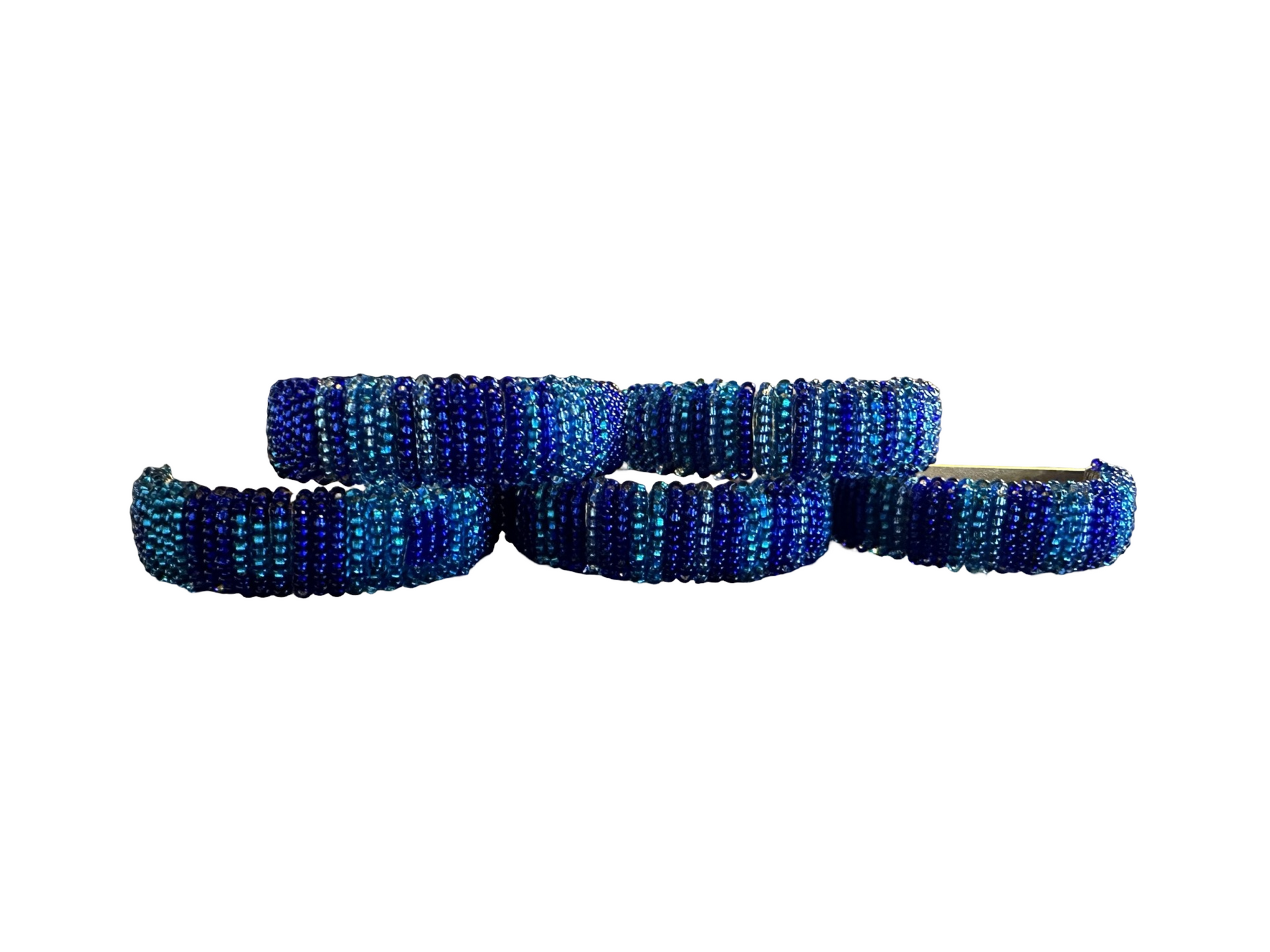 Set of five beaded napkin rings by Phoebe, featuring colorful, handcrafted bead designs for elegant table settings.