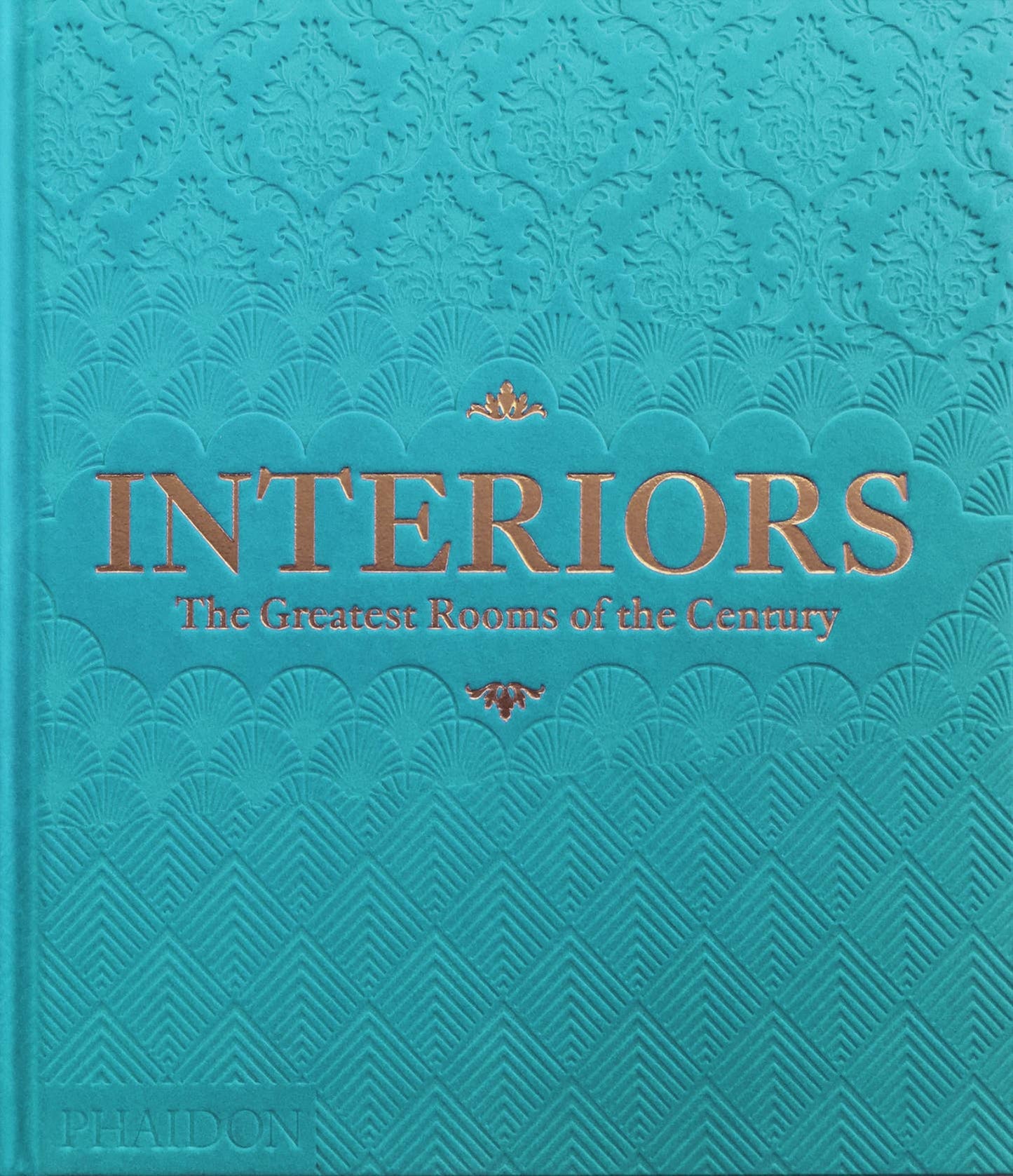 Sky blue cover of Phaidon’s Interiors: The Greatest Rooms of the Century book showing modern interior room designs.