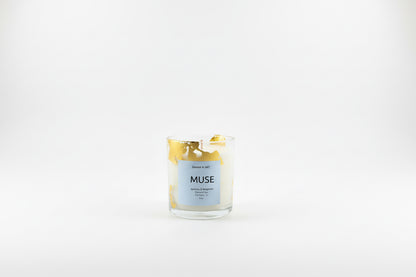 Ozmun Home Sahar N Art Candle showing a decorative candle with intricate design in a glass holder on a wooden surface.