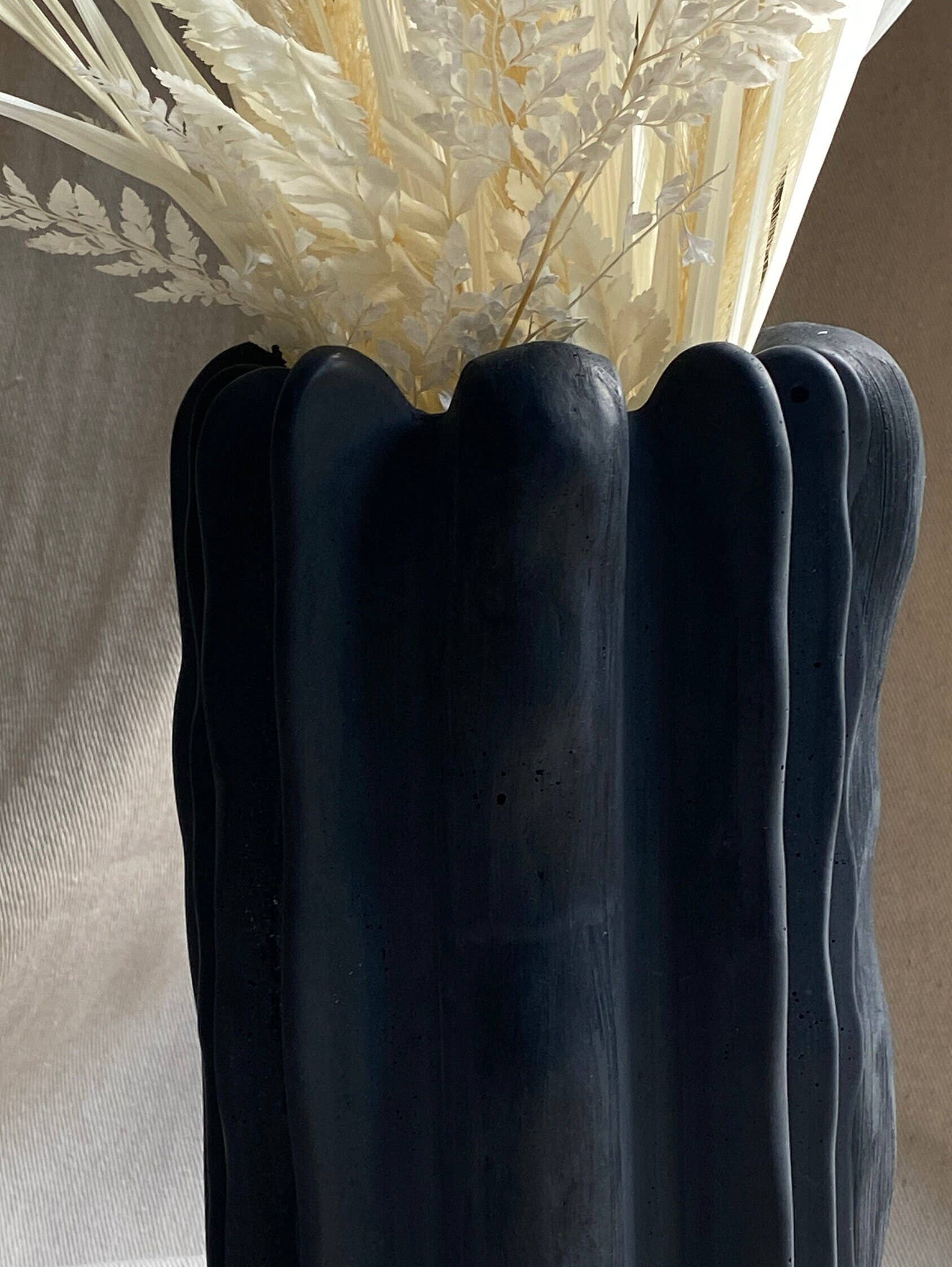 Forma concrete vase by Atelier La Rouleuse shown in natural gray with a smooth, rounded shape and minimalist design.