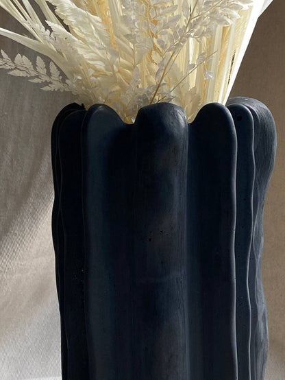 Forma concrete vase by Atelier La Rouleuse shown in natural gray with a smooth, rounded shape and minimalist design.