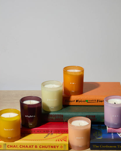 White Woods & Amber Aura 7oz candle by wxy in a white jar with a single wick and a cozy, inviting appearance.