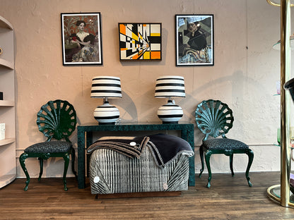 Faux Malachite console table by The Vault Creative with sleek black metal legs and vibrant green faux stone surface.
