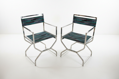 Pair of vintage chrome directors chairs with black fabric seats and wooden armrests, stylish retro seating from The Vault Creative.