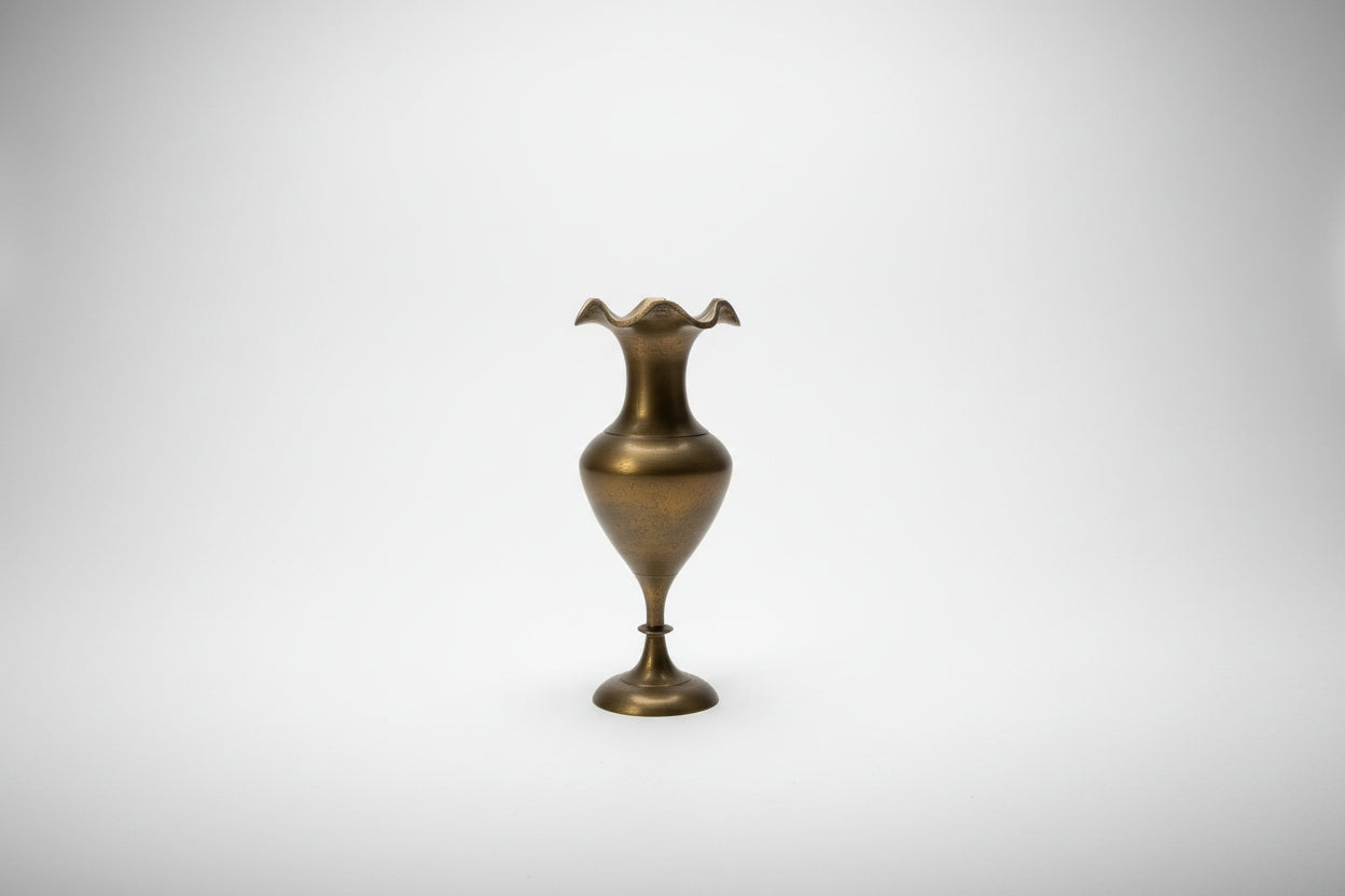 Brass vintage wavy Bud vase by The Vault Creative with a sleek, curved design and polished finish on a neutral background.