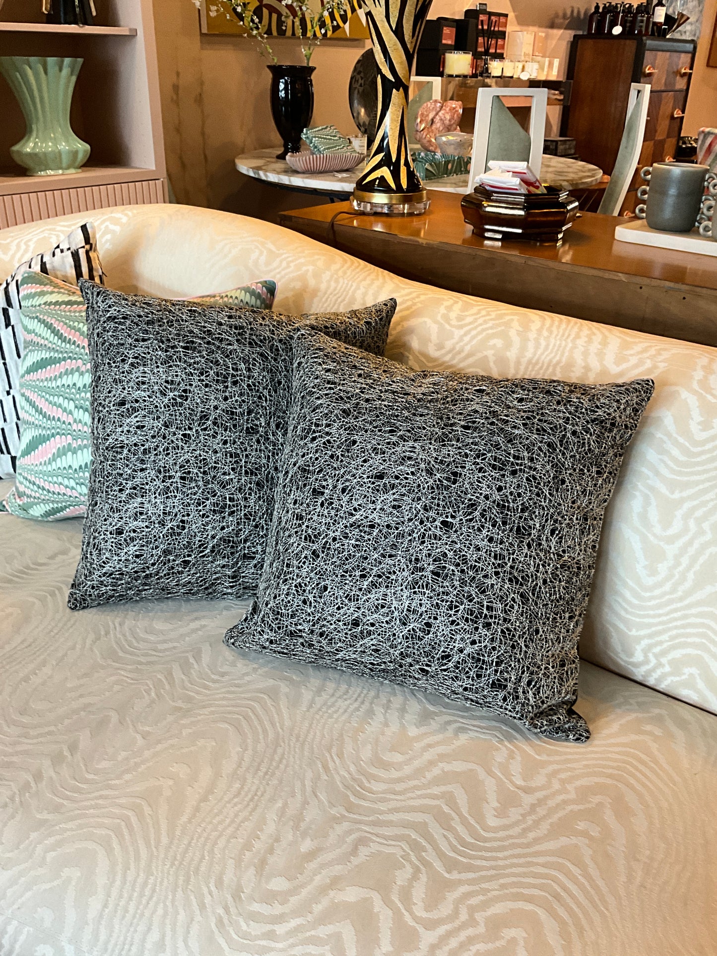Silver and black metallic pillow from The Vault Creative, featuring a stylish, shiny cushion with a modern design.