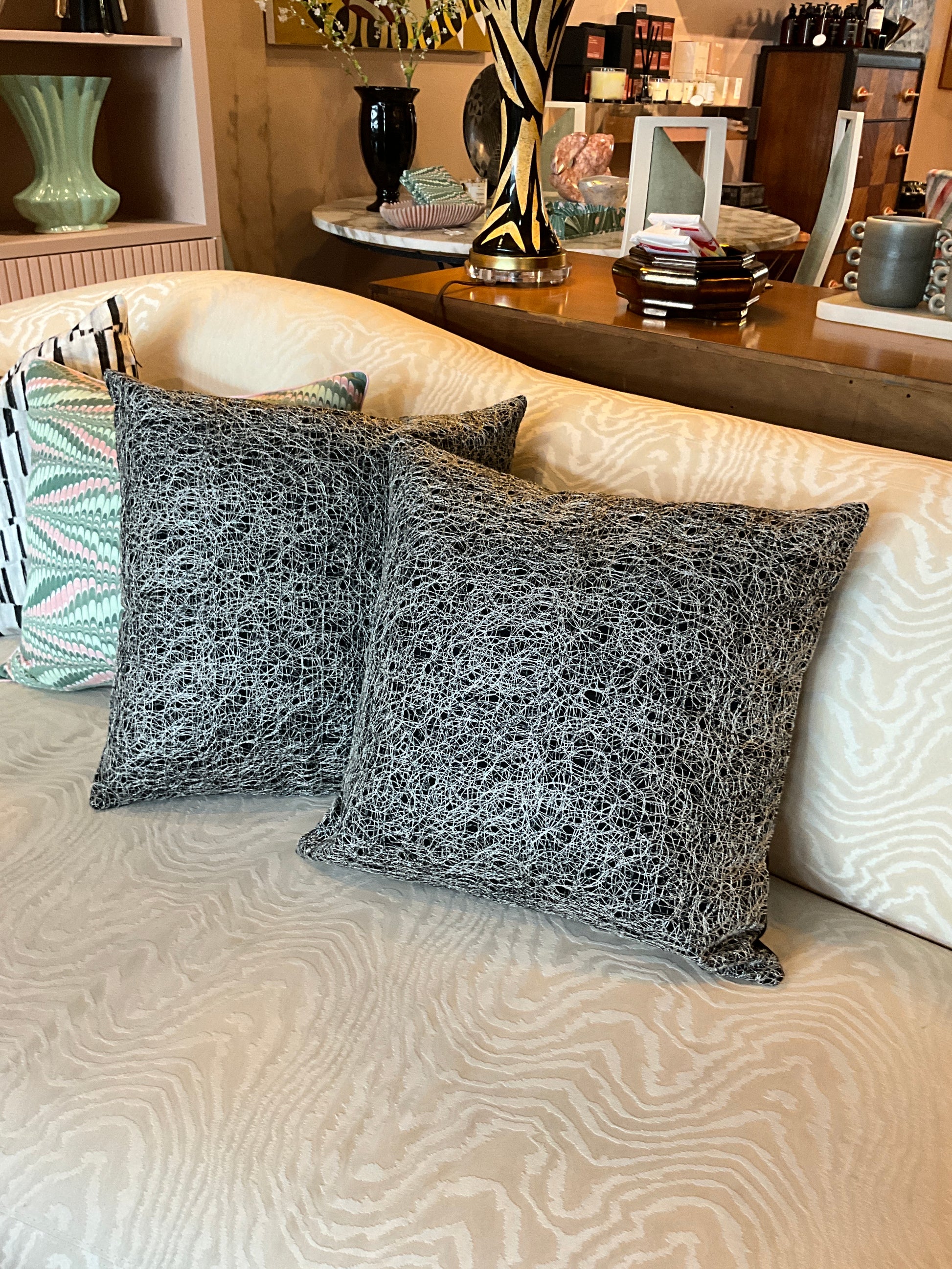 Silver and black metallic pillow from The Vault Creative, featuring a stylish, shiny cushion with a modern design.