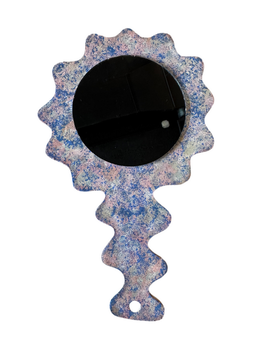 Ceramic Squiggle mirror by Stone Textile featuring a unique wavy ceramic frame and round reflective glass surface.