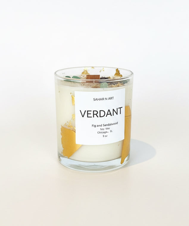 Ozmun Home Sahar N Art Candle with intricate decorative details and warm glow, displayed on a neutral surface.