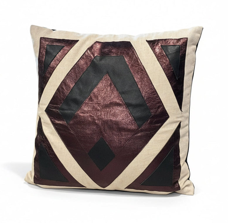 Leather patchwork pillow by The Vault Creative featuring a mixed leather and fabric design, soft and decorative home accent.