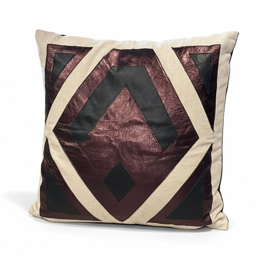 Leather patchwork pillow by The Vault Creative featuring mixed leather patches and a soft, textured surface for stylish home decor.