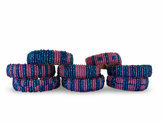Set of 8 Phoebe hand-beaded napkin rings with intricate colorful beadwork, perfect for elegant table settings.