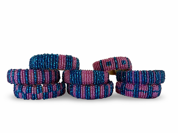 Set of 8 Phoebe hand-beaded napkin rings with intricate colorful beadwork, perfect for elegant table settings.