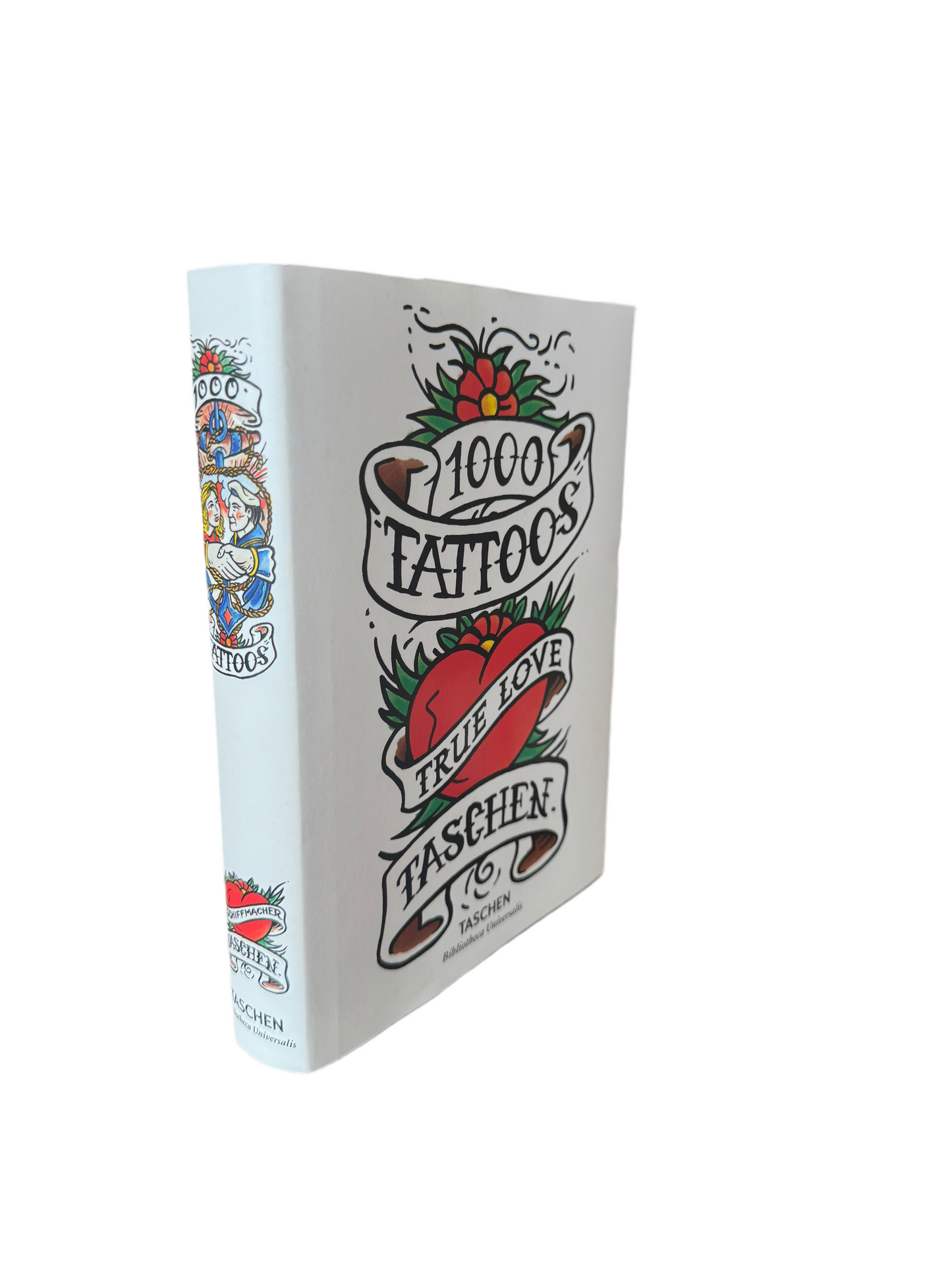 Open book titled "1000 Tattoos" by Ozmun Home showcasing black and white tattoo designs on pages.