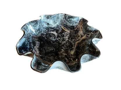 Big black gem stone resin bowl by Stone Textile Studio, featuring a smooth, glossy surface and rounded shape.