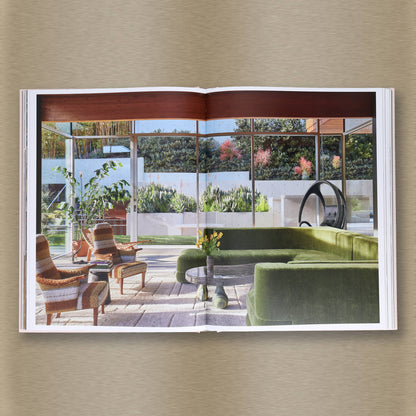 Open Livable Luxe book by Chronicle Books showing colorful interior pages with modern decor ideas and stylish living room images.