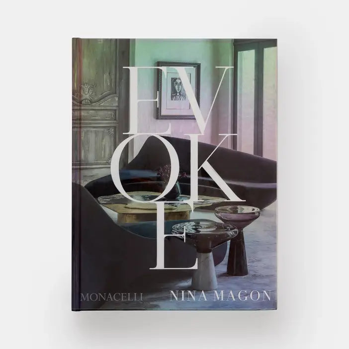 Open book titled "Evoke: Nina Magon" by Phaidon, showing colorful interior pages with design images and artwork.