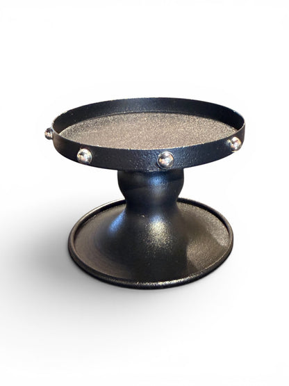 The Vault Creative P.Grunsfeld candle holder with a sleek, modern design and metallic finish, suitable for holding a single candle.