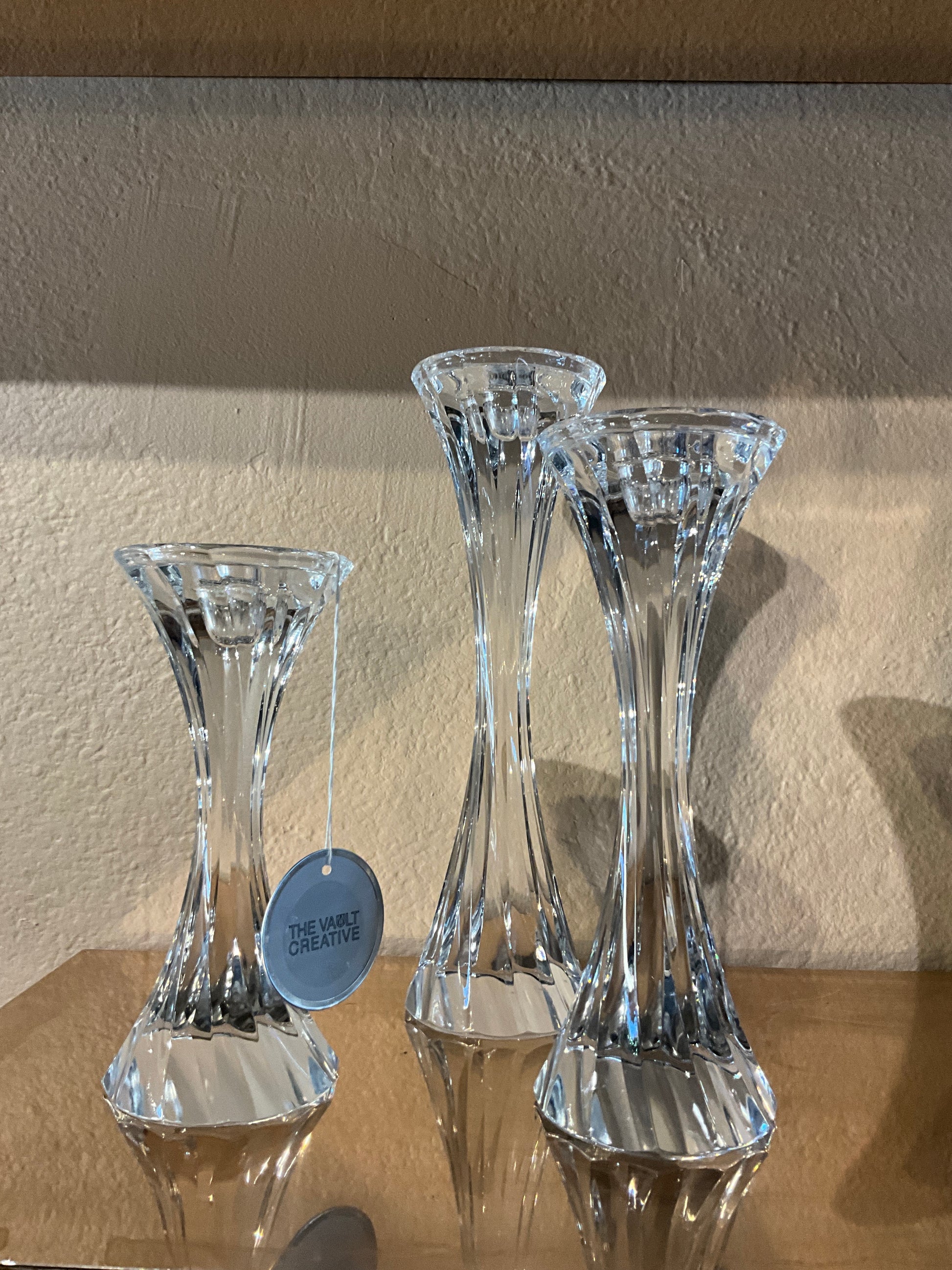 Twisted crystal candle holders set by Ozmun Home with clear, faceted glass design for elegant tabletop decor.