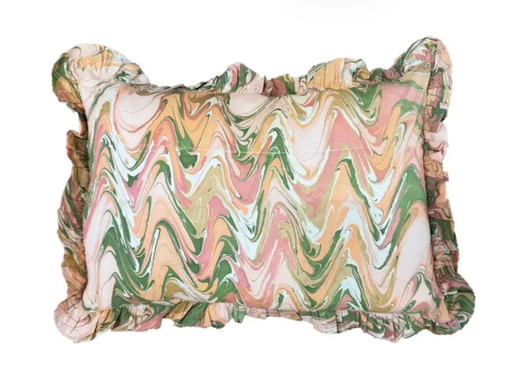 Peony Bloom Ruffled Hand-Marbled Pillow by The Vault Creative featuring ruffled edges and vibrant floral marbled fabric.
