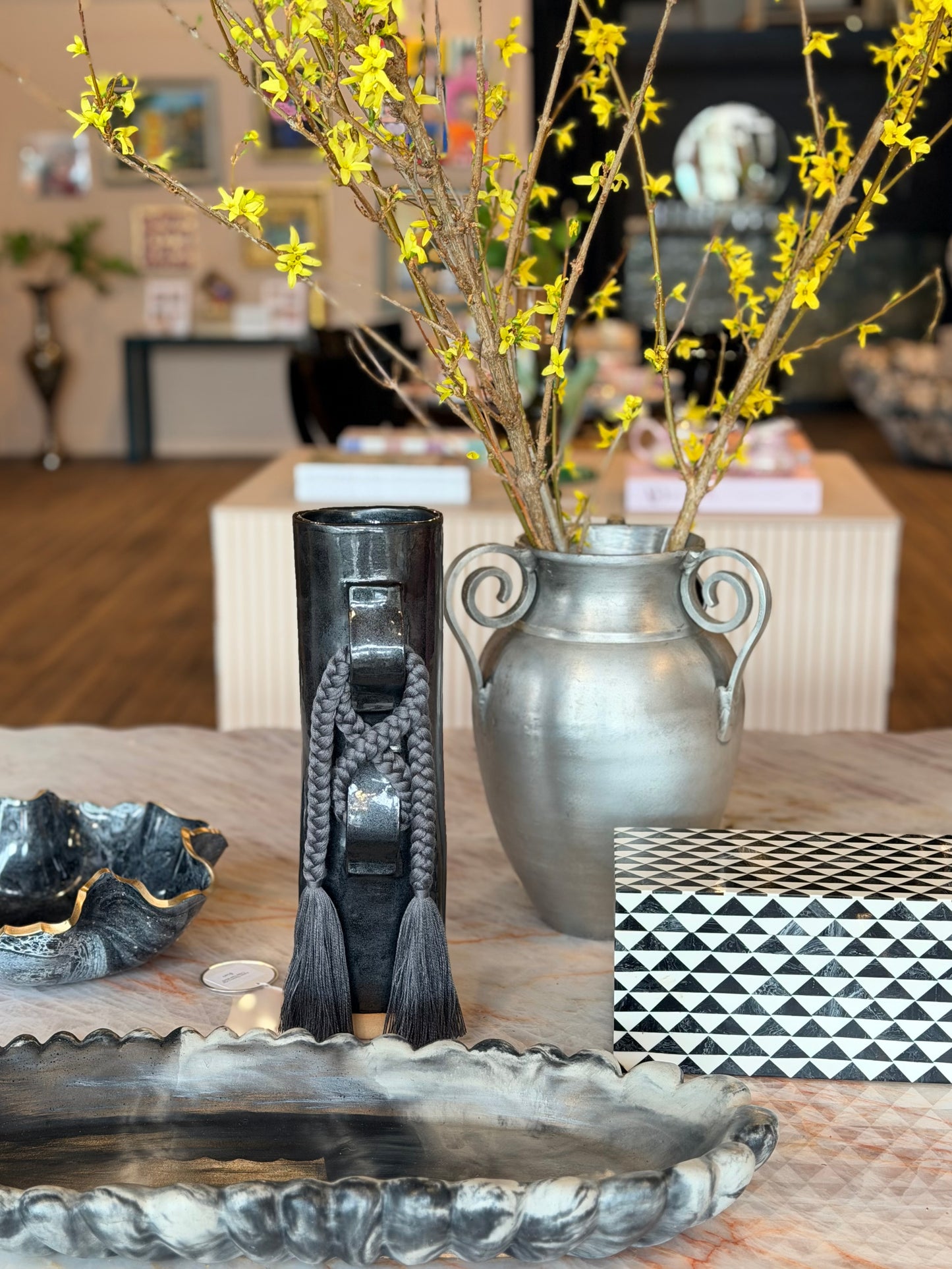 Cast metal urn vase by Ozmun Home featuring a classic design with a smooth, rounded shape and a durable metallic finish.