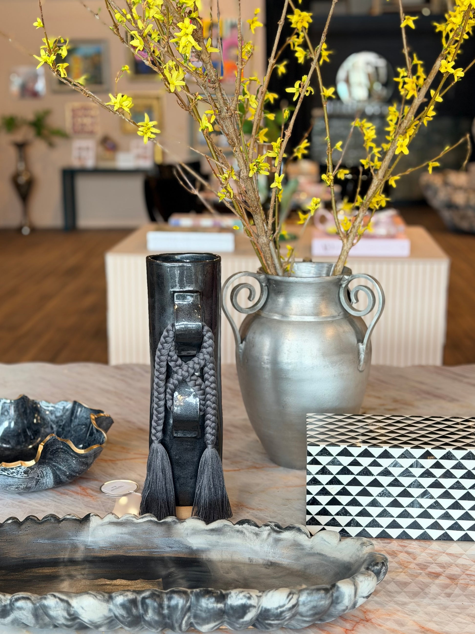 Cast metal urn vase by Ozmun Home featuring a classic design with a smooth, rounded shape and a durable metallic finish.