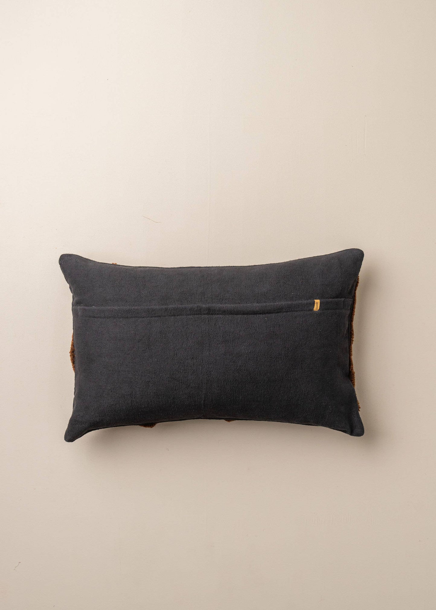 Black and chocolate abstract cushions by Saardé featuring modern geometric patterns and soft textured fabric.