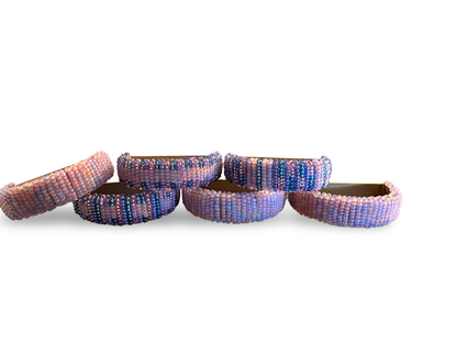 Set of six beaded napkin rings by The Vault Creative, featuring colorful and intricate bead designs for elegant table settings.