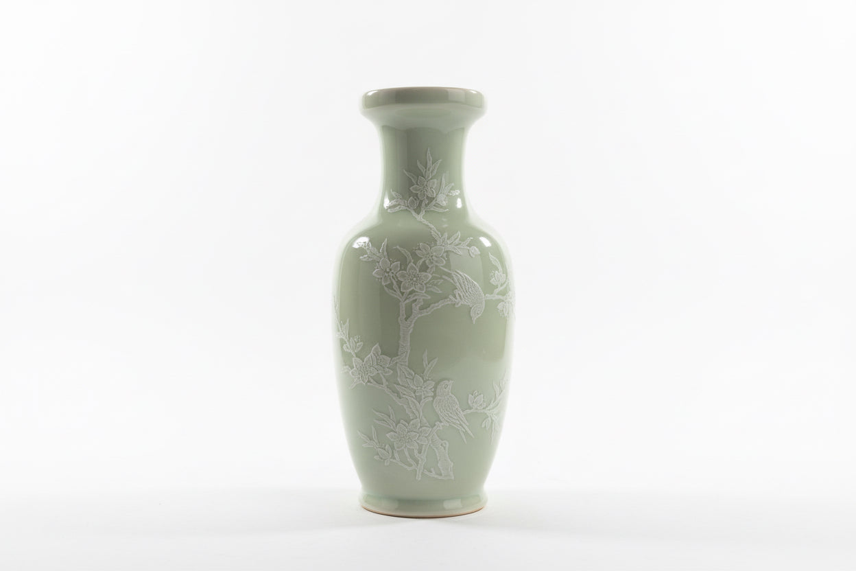 Minty Asian vase by The Vault Creative with intricate patterns and a glossy finish, displayed on a wooden surface.