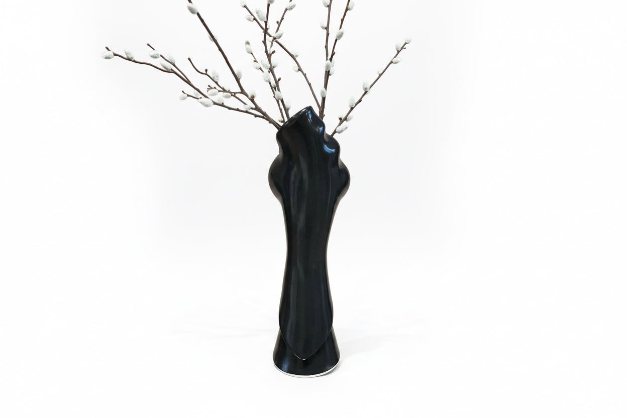 Elegant tulip-shaped ceramic vase by The Vault Creative with a smooth white finish and a narrow opening.