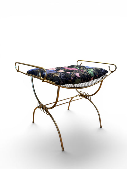 Vintage gold vanity bench with ornate legs and cushioned seat by The Vault Creative, perfect for elegant bedroom décor.